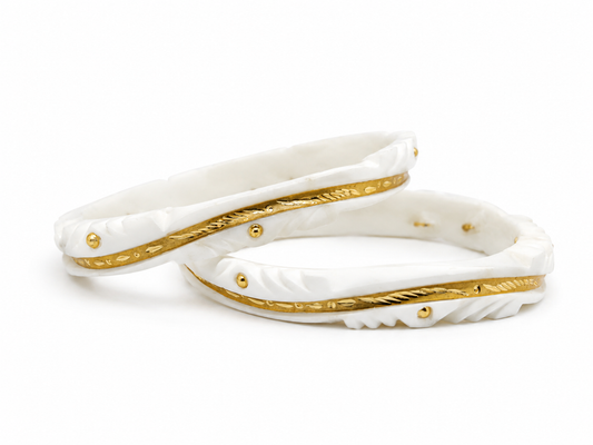 Add timeless elegance to your traditional look with this beautifully crafted White & Gold Designer Shakha Pair. Featuring intricate carved detailing with luxurious gold-tone accents, this lightweight and stylish set is perfect for weddings, festivals, and everyday ethnic wear.